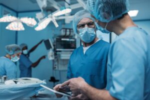 doctors using tablet in surgery room