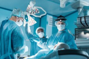 multicultural surgeons and patient during surgery in operating room