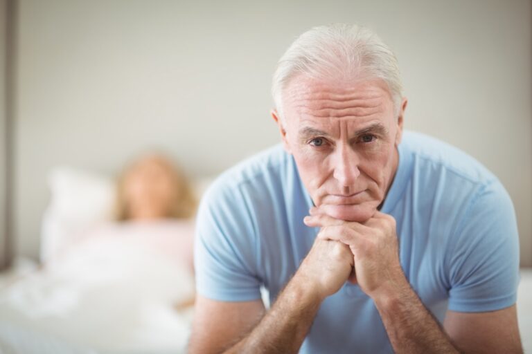 Worried senior man sitting at home