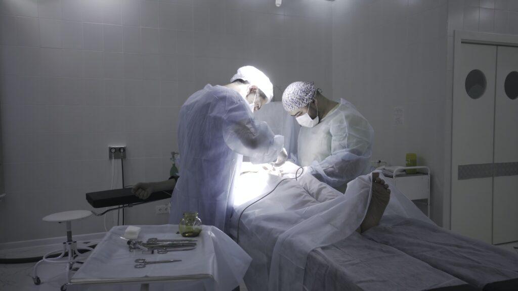 Two professoinal surgeons performing phimosis surgery. Action. Male health concepts, medical